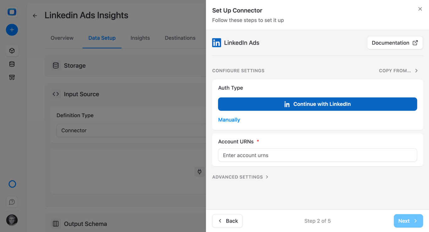 Set Up Connector dialog in OWOX Data Marts, step 2 of 5, for LinkedIn Ads with a Continue with LinkedIn button, a Manually link and a required Account URNs field – one sign-in and the account ID connect the source